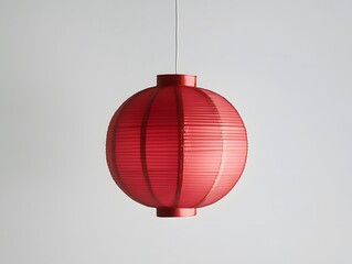 Obraz premium Red Paper Lantern Hanging from a White Ceiling