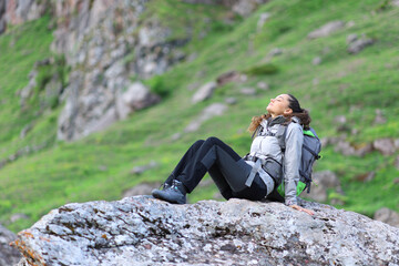 Hiker resting and breathing sitting in nature