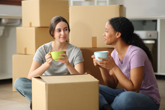 Two interracial roommates planning house move