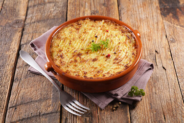 potato gratin, shepherd's pie on wooden background