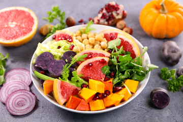 mixed vegetarian salad with grapefruit, avocado, pumpkin, pomegranate and onion- healthy eating