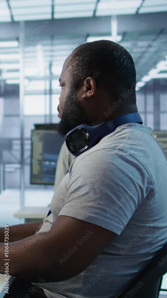 Poster portrait of joyful technician working in high tech workplace providing computing resources for diffe