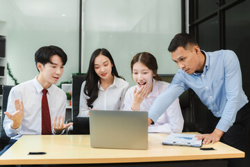 Business team working on a project in the office or reviewing and discussing a business project.