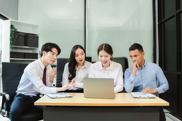 Business team working on a project in the office or reviewing and discussing a business project.