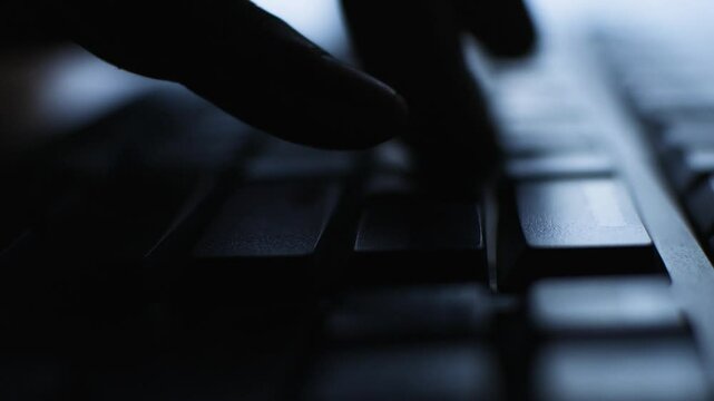Close Up Silhouette Two Hand Typing on Black Keyboard Personal Computer with Shallow Depth of Field
