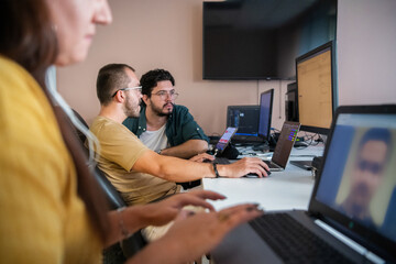 Top view of programmer diligently testing smartphone applications while sitting in their office.