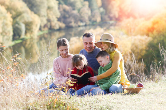 Family reading the Bible in nature