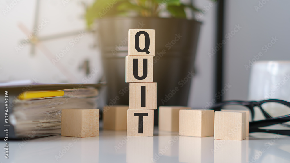 Fototapete quit text or word on cube shape wooden block toy for business design concept and activity.