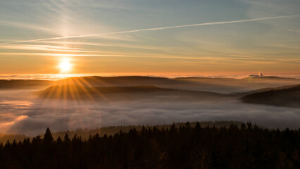 Sunset in the Teplice-Adršpašské rocks. The sun is low on the horizon and the inverted clouds create stunning scenery that makes it seem as if you are above the clouds.