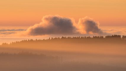 Sunset in the Teplice-Adršpašské rocks. The sun is low on the horizon and the inverted clouds...