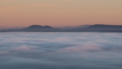 Sunset in the Teplice-Adršpašské rocks. The sun is low on the horizon and the inverted clouds...