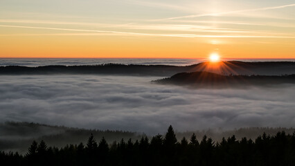 Sunset in the Teplice-Adršpašské rocks. The sun is low on the horizon and the inverted clouds...