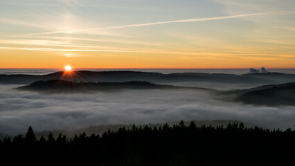 Sunset in the Teplice-Adršpašské rocks. The sun is low on the horizon and the inverted clouds...