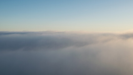 Sunset in the Teplice-Adršpašské rocks. The sun is low on the horizon and the inverted clouds create stunning scenery that makes it seem as if you are above the clouds.