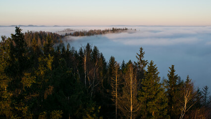 Sunset in the Teplice-Adršpašské rocks. The sun is low on the horizon and the inverted clouds create stunning scenery that makes it seem as if you are above the clouds.