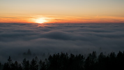 Sunset in the Teplice-Adršpašské rocks. The sun is low on the horizon and the inverted clouds create stunning scenery that makes it seem as if you are above the clouds.