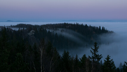 Sunset in the Teplice-Adršpašské rocks. The sun is low on the horizon and the inverted clouds...