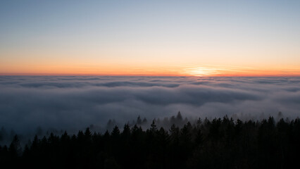 Sunset in the Teplice-Adršpašské rocks. The sun is low on the horizon and the inverted clouds create stunning scenery that makes it seem as if you are above the clouds.