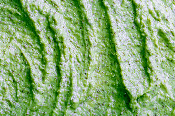 Green smoothie with celery, spinach, kiwi, cucumber and other vegetables and fruits. Healthy yogurt. Sorbet texture. Delicious diet food close-up as a background.