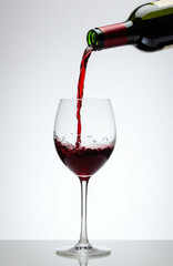 Luxury wine photography featuring suspended crystal glass with dynamic wine splash effects, perfect for premium beverage marketing and upscale restaurant promotion