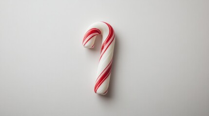 Mini candy cane with red, white, and green stripes, isolated on a plain white background