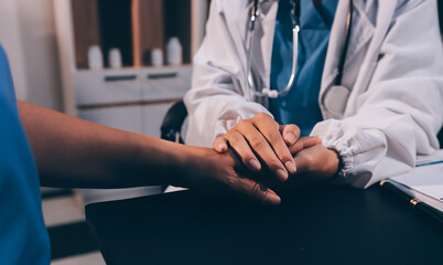 Kind male doctor wearing white coat consulting elder senior female patient holding hand of older woman giving help, safety, empathy and support, showing care and compassion concept. Close up view
