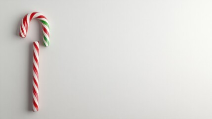 Shiny candy cane stick with red and green stripes, adding holiday cheer on a plain white background