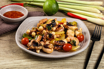 Roasted octopus with vegetables and oil