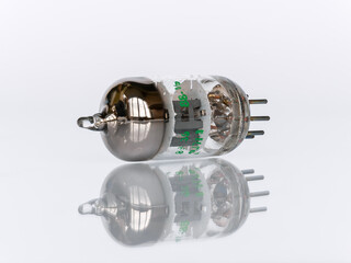 Close up of 7-Pin vacuum tube isolated on white background with reflection