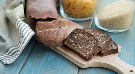 Fresh dark rye bread with whole grain on rustic wood