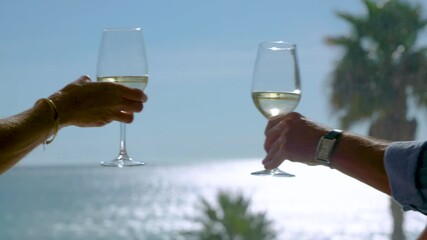 two people toasting with glasses of white wine  - Powered by Adobe
