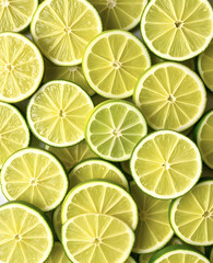 Fresh juicy green lime slices. Texture of sliced ​​citrus fruits. Lime slice patterns. Bright summer style. Flat lay, top view.