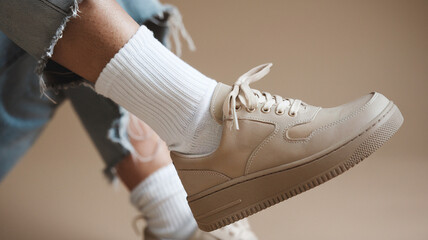 Beige Sneakers with White Socks and Ripped Jeans