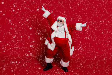 Photo of funky crazy carefree old man dance performance wear santa hat costume isolated red color background