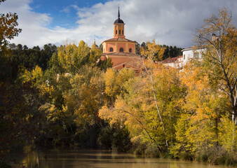 a church stands out on a path next to the river