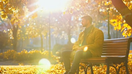 A man finds peace among autumn leaves