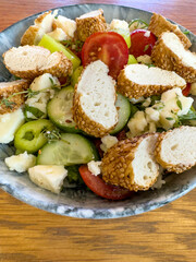 breakfast with sliced turkish bagel simit on fresh salad and cheese
