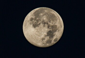 Close-up of the full moon in night sky