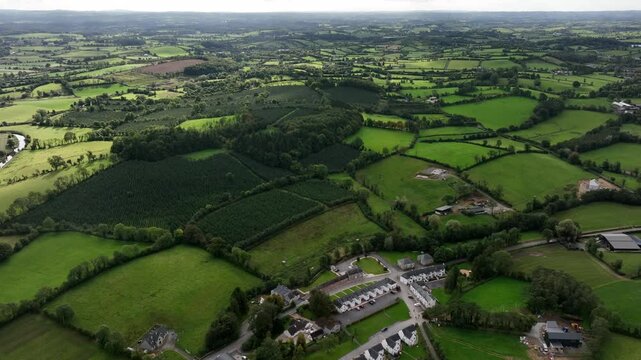 Mullan Village, County Monaghan, Ireland, September 2022. Drone orbits clockwise with breathtaking views south to Emyvale showcasing the vibrant countryside close to the border with Northern Ireland.