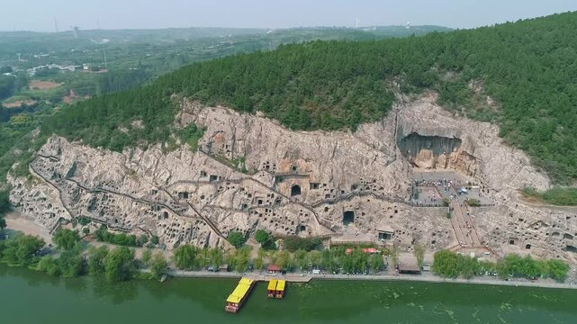 Aerial drone view of Longmen Grottoes Caves Yi River Luoyang in Henan province, China. Chinese Buddhist art Longmen Caves. Longmen Grottoes Caves in Luoyang, China.