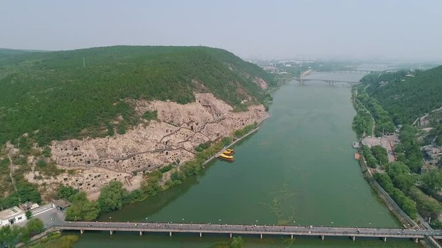 Aerial drone view of Longmen Grottoes Caves Yi River Luoyang in Henan province, China. Chinese Buddhist art Longmen Caves. Longmen Grottoes Caves in Luoyang, China.