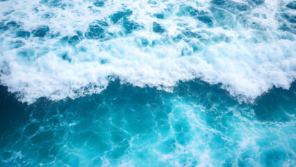 Fototapeta premium Beautiful blue sea water with white foam, top view