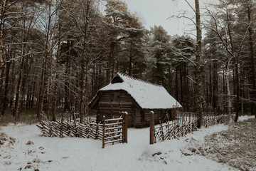 Snowy wooden cabin in a tranquil forest setting of Estonia during winter season