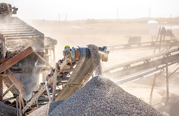 Vibrating screen stone crusher in operation. Crushing stones in a quarry for processing minerals,...