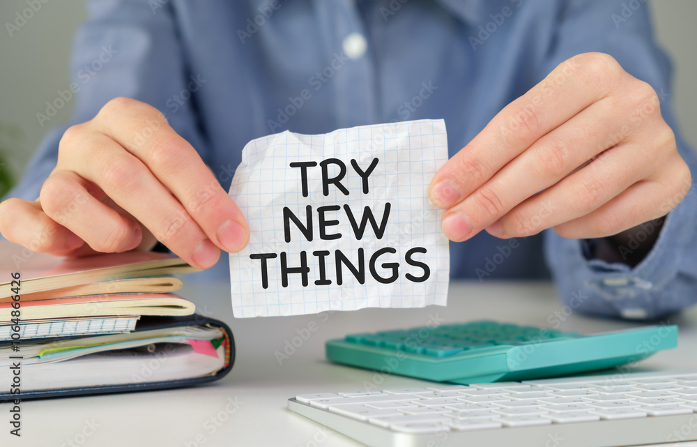 Poster concept try new things message on paper notebook in hands, business concept.