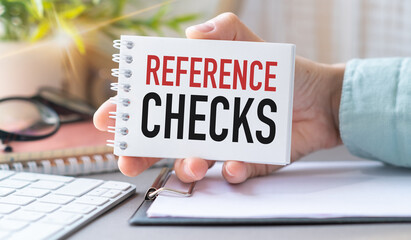 Reference Checks Text on an Open Notebook in Hand, Calculator, Business Concept