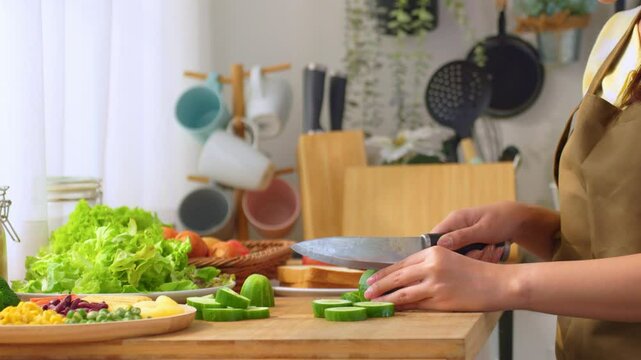 Close up of woman cooking healthy foods in kitchen in morning at home. 