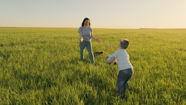 Mom And Son Are Playing Soccer On Field. Joyful Moments In Nature. Family Football Training. Happy Family With Football Ball On A Field. Gimbal Stabilize.