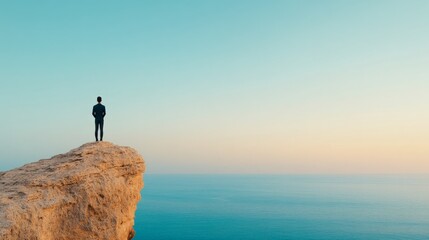 Man on Clifftop at Dawn: A lone figure stands on a cliff overlooking a serene ocean at dawn. The image evokes feelings of contemplation, peace, and the vastness of possibility. 