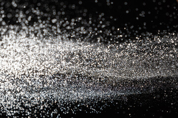 Abstract black and white background of pouring flour, space for text